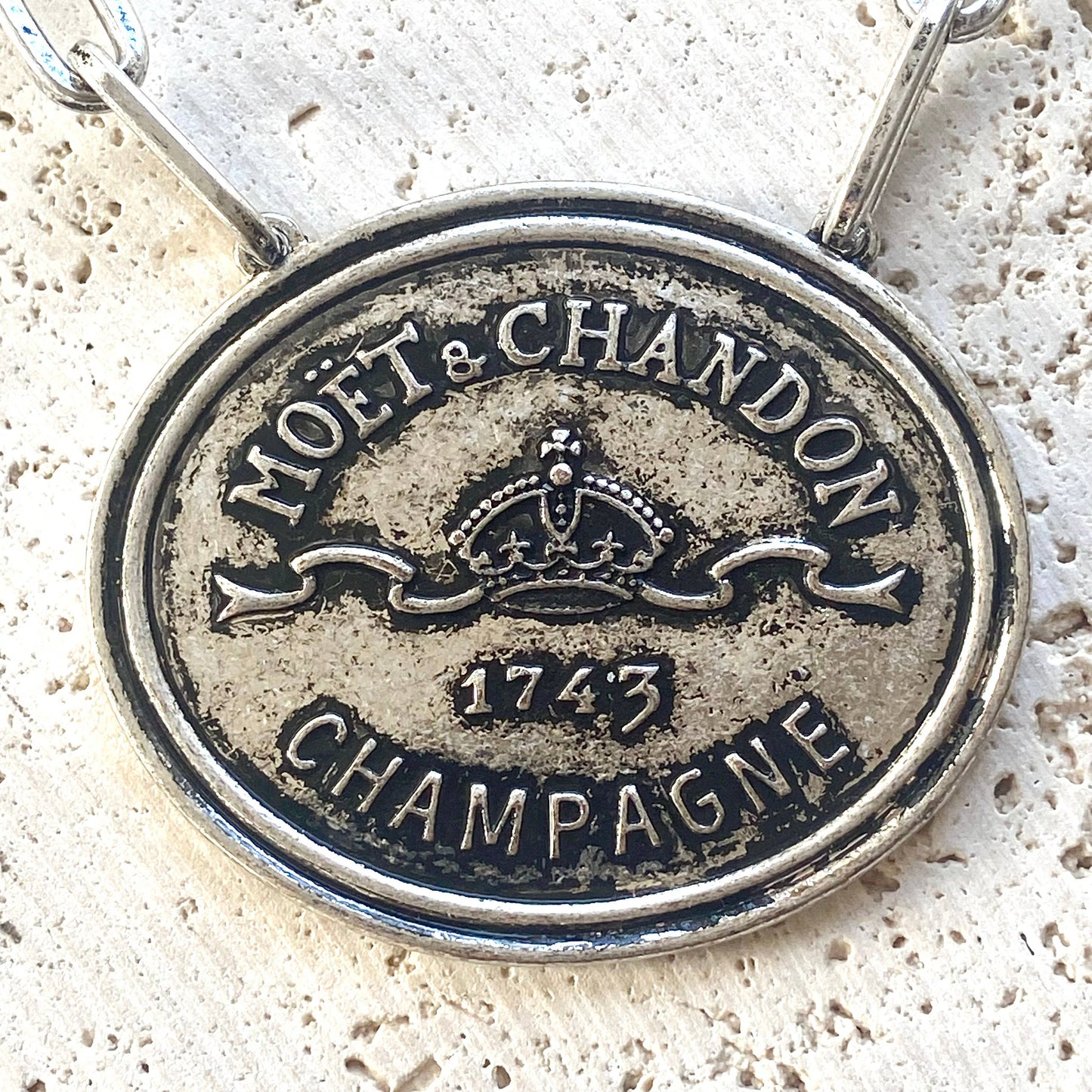French champagne, coin, necklace, statement